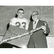 Toronto Argonaut Bobby Kuntz and Sam Shopsowitz, Toronto, 29 October 1961. Ontario Jewish Archives, Blankenstein Family Heritage Centre, item 5024.|Sam Shopsowitz was very involved in various sports teams in Toronto and Shopsy's Deli was a sponsor of the Marlboros, Toronto's Pee Wee Hockey team.